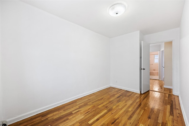 unfurnished room featuring hardwood / wood-style flooring