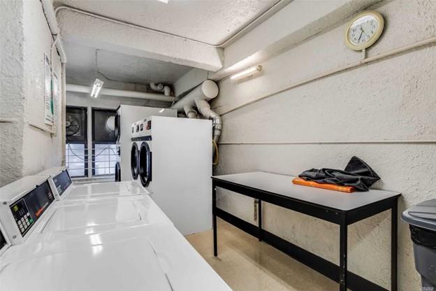 laundry room featuring washing machine and clothes dryer