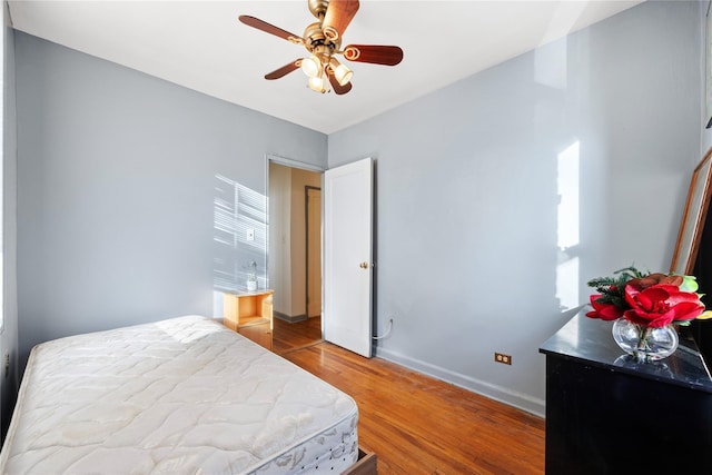 bedroom with hardwood / wood-style floors and ceiling fan