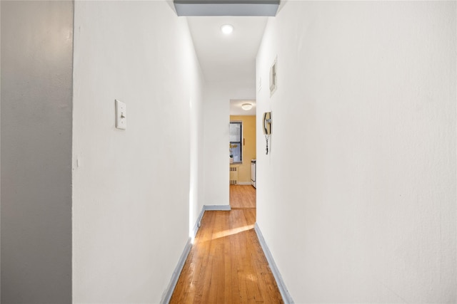 corridor with hardwood / wood-style flooring