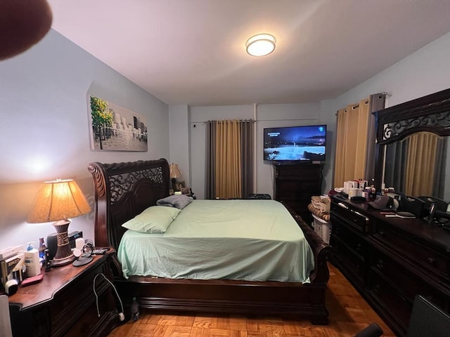 bedroom featuring parquet flooring