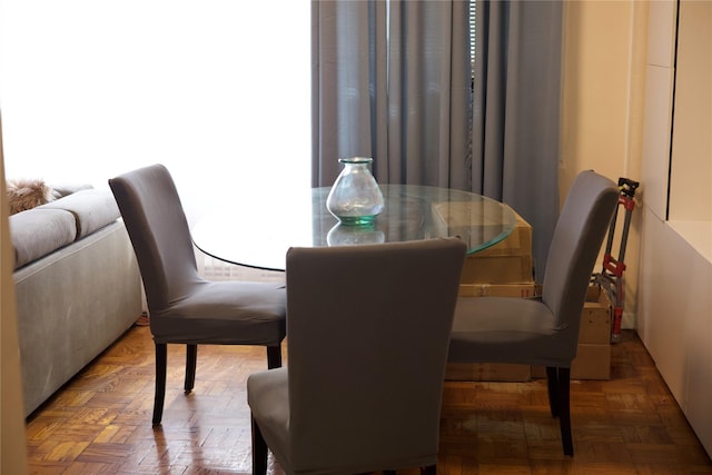 dining area featuring dark parquet floors