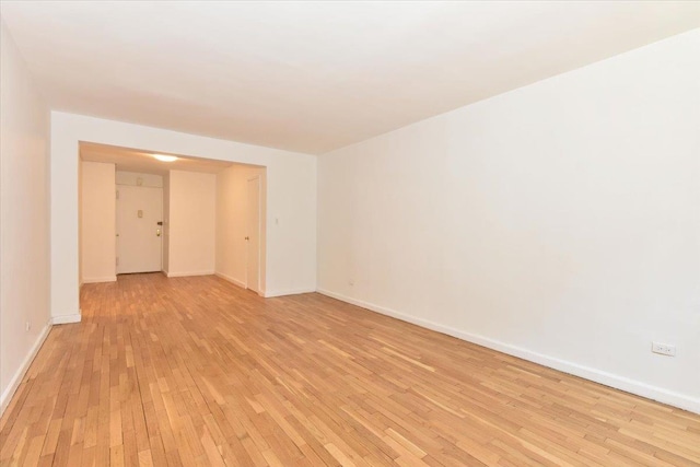 empty room with light hardwood / wood-style floors