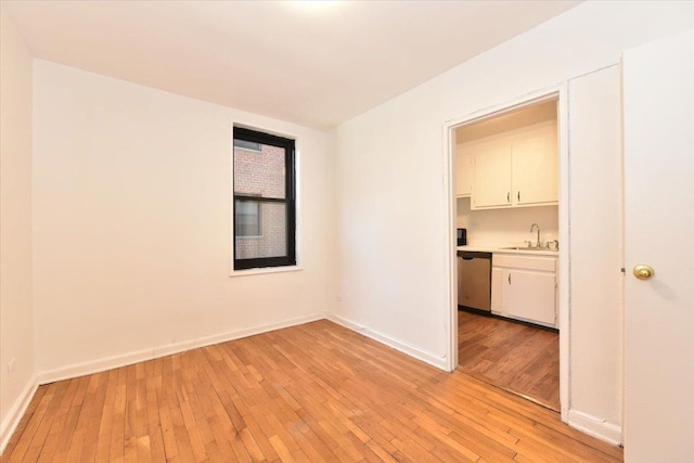 empty room with sink and light hardwood / wood-style floors