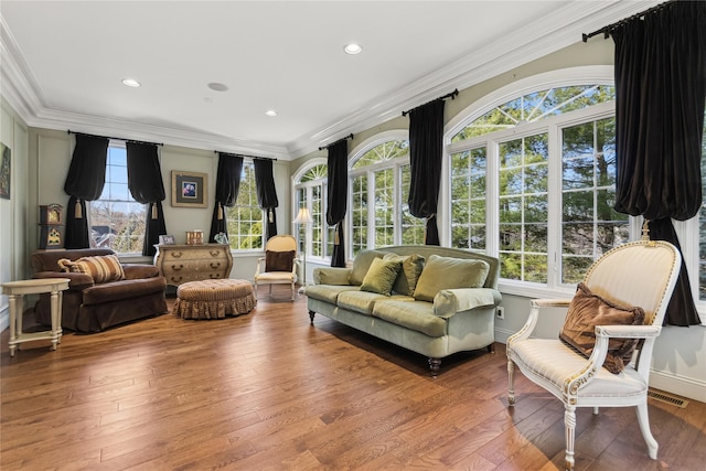 sitting room featuring wood-type flooring and crown molding