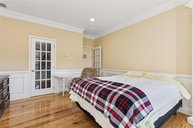 bedroom with light hardwood / wood-style floors and crown molding