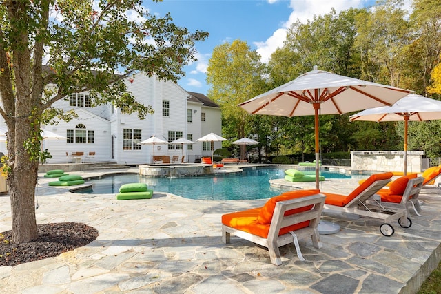 view of swimming pool featuring an in ground hot tub and a patio area