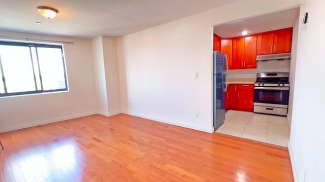 kitchen with stainless steel appliances and light hardwood / wood-style floors