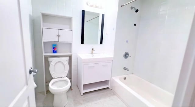 full bathroom featuring tiled shower / bath, vanity, and toilet