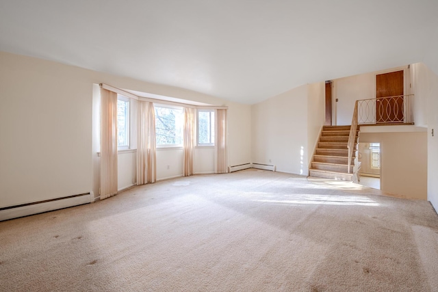 carpeted spare room with a baseboard radiator and lofted ceiling