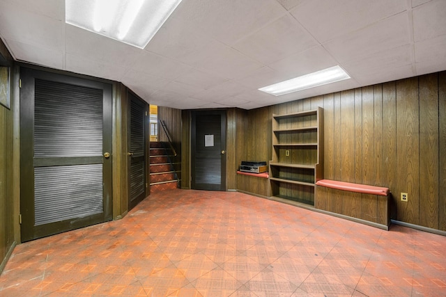 unfurnished living room with wooden walls