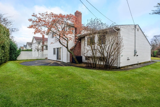 back of house with a lawn