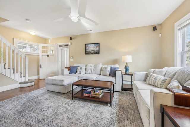 living room featuring hardwood / wood-style flooring and ceiling fan