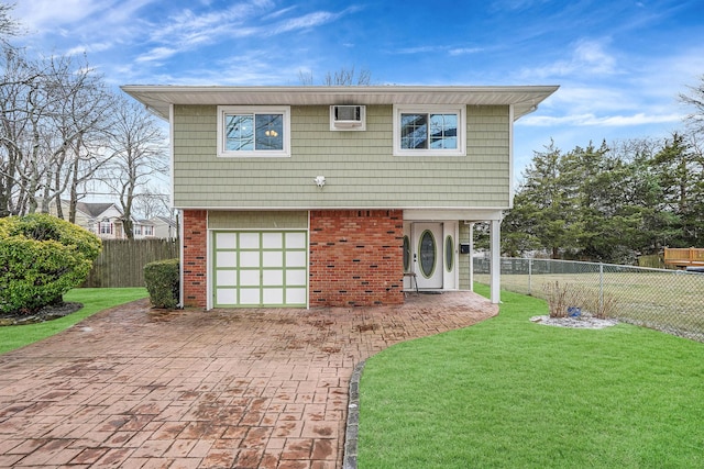 view of front of house with a garage and a front lawn