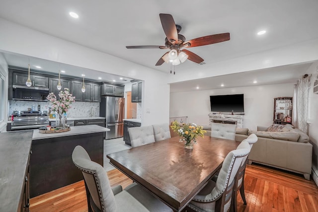 dining room featuring light hardwood / wood-style flooring and ceiling fan