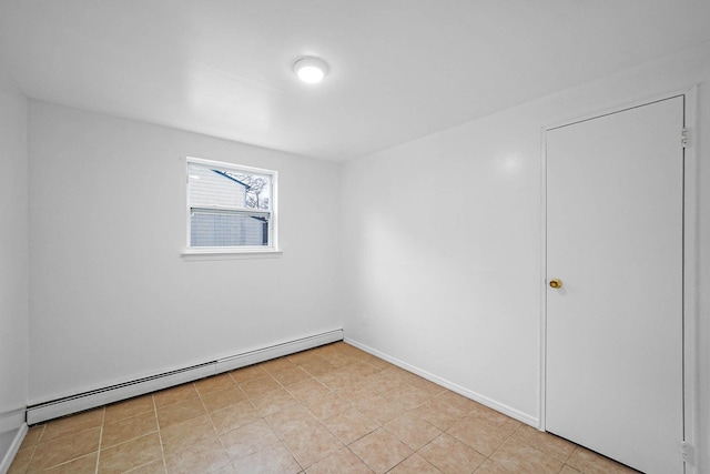 unfurnished room featuring a baseboard heating unit