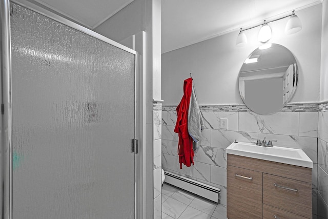 bathroom with vanity, a shower with door, a baseboard heating unit, tile walls, and tile patterned flooring