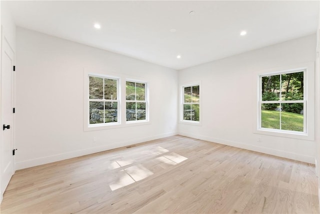 empty room with light hardwood / wood-style floors