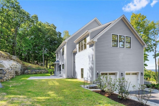 view of property exterior with a garage and a lawn