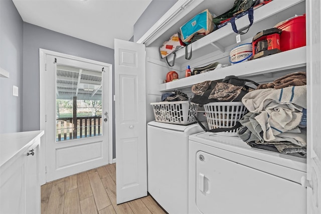 laundry room featuring separate washer and dryer and light hardwood / wood-style floors