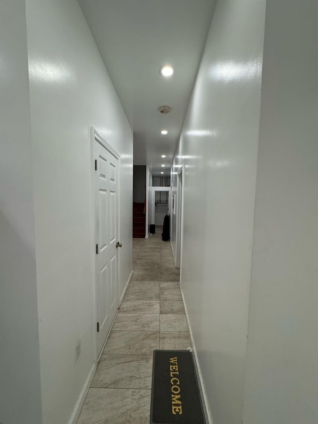 hallway with baseboards and recessed lighting