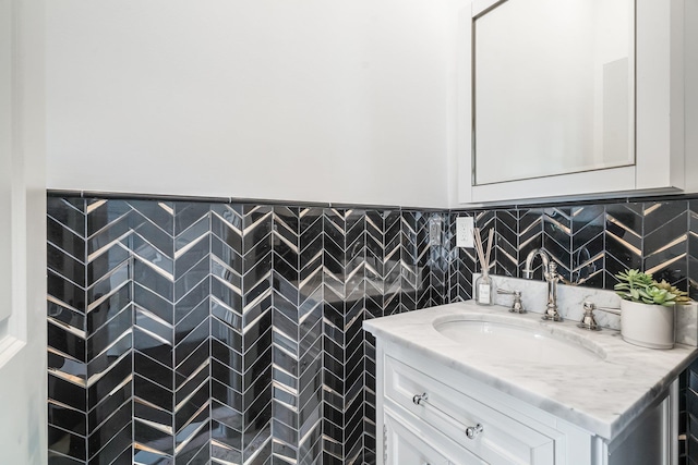 bathroom featuring vanity and tile walls