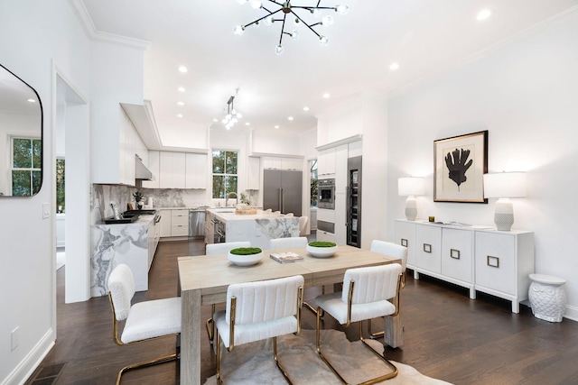 dining space with an inviting chandelier, ornamental molding, dark hardwood / wood-style flooring, and sink