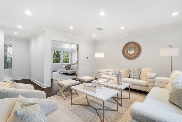 living room with crown molding and light hardwood / wood-style flooring