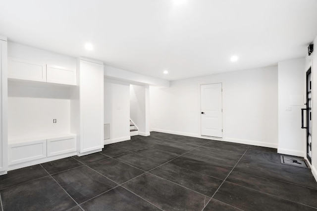 basement featuring dark tile patterned flooring