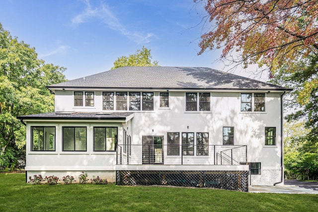 rear view of property featuring a wooden deck and a yard