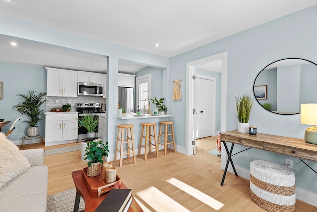 living room with light hardwood / wood-style flooring