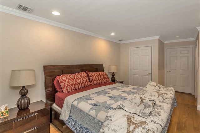 bedroom featuring ornamental molding and light hardwood / wood-style floors