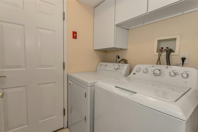 laundry area with cabinets and separate washer and dryer