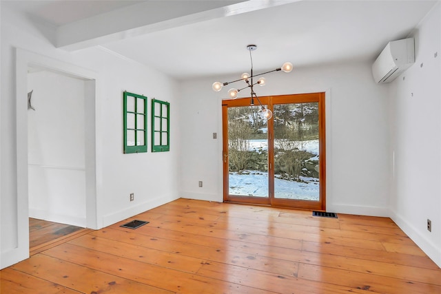 unfurnished dining area with a wall mounted air conditioner, wood-type flooring, an inviting chandelier, and beamed ceiling