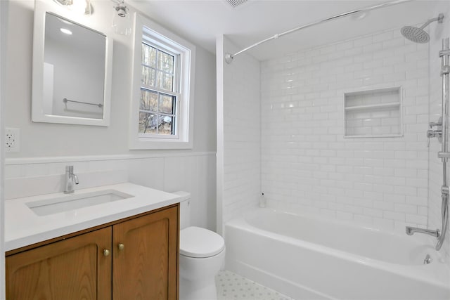 full bathroom featuring vanity, toilet, and tiled shower / bath combo