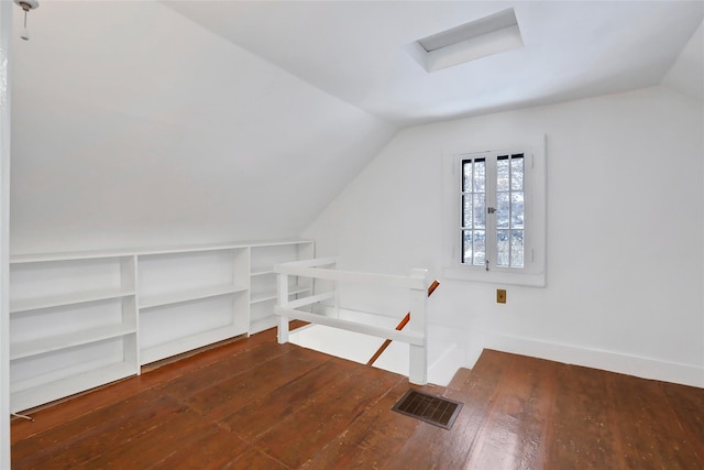 bonus room with dark wood-type flooring and vaulted ceiling