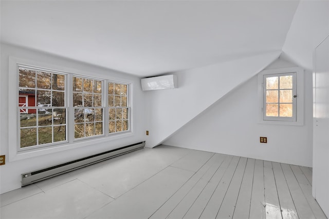 bonus room with a baseboard radiator, a wall unit AC, and lofted ceiling