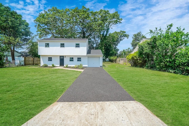 view of front of house with a garage and a front lawn