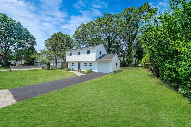 view of front of property with a garage and a front lawn