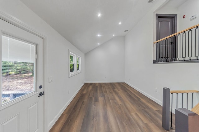 empty room featuring dark hardwood / wood-style flooring and vaulted ceiling