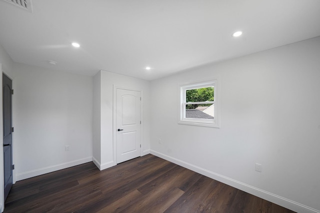 empty room featuring dark hardwood / wood-style flooring