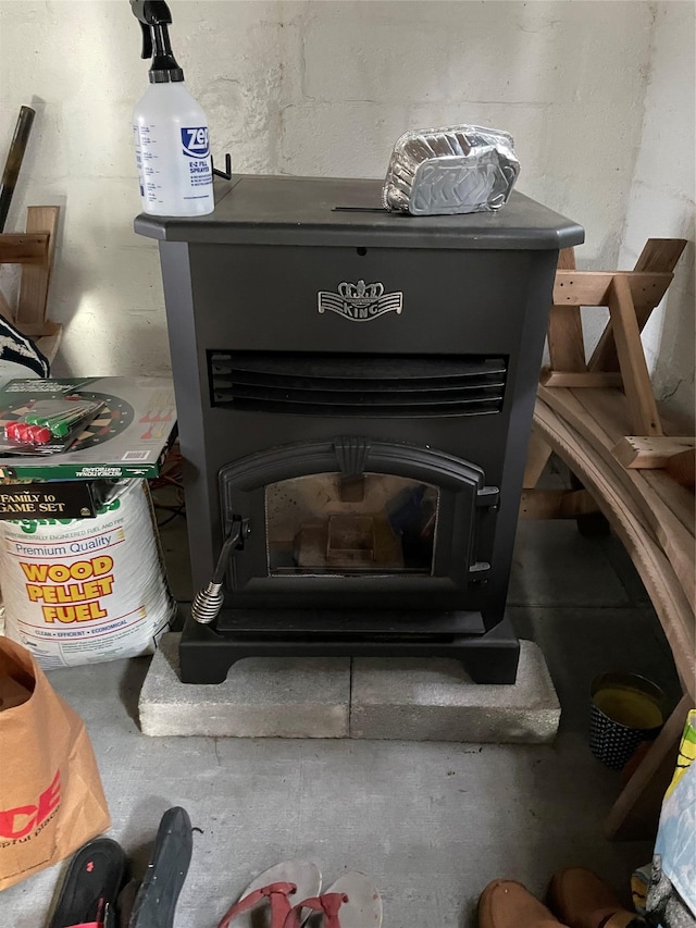 interior details with concrete flooring and a wood stove