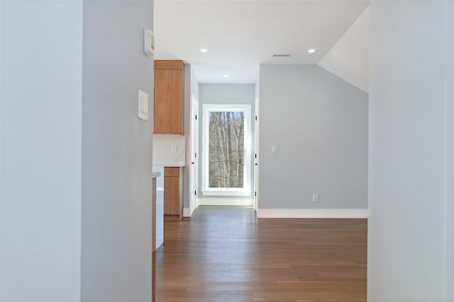 interior space featuring recessed lighting, dark wood-style flooring, and baseboards