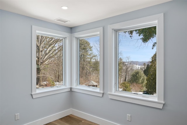 interior space featuring recessed lighting, wood finished floors, visible vents, and baseboards