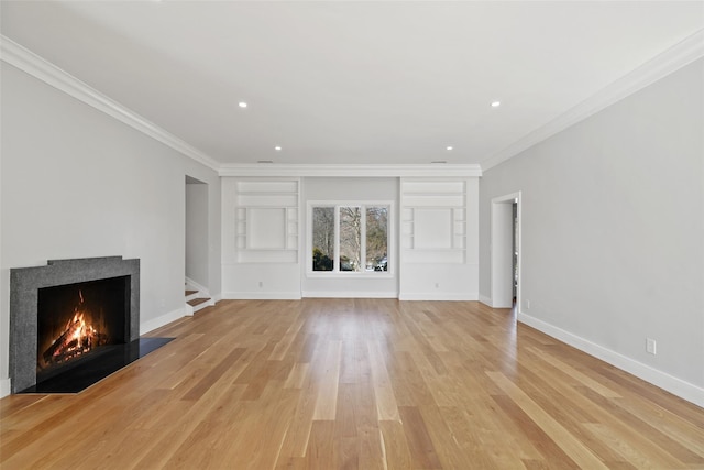 unfurnished living room featuring baseboards, a fireplace with flush hearth, ornamental molding, and light wood-type flooring