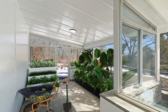 sunroom featuring vaulted ceiling