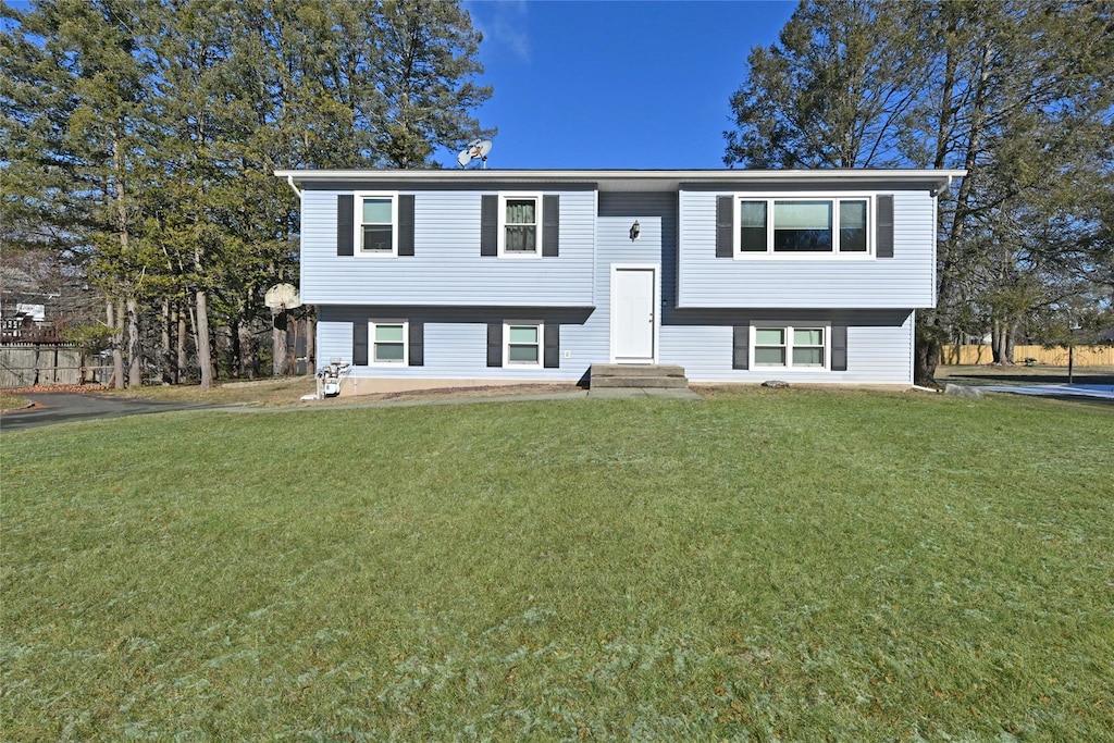 bi-level home with a front lawn