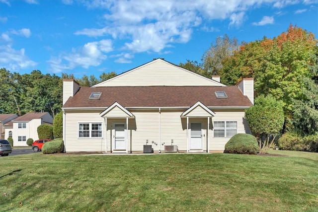 view of front facade featuring central AC and a front yard