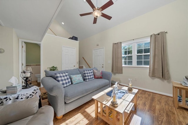 living room with hardwood / wood-style floors, ceiling fan, and vaulted ceiling