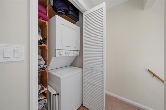 laundry room with stacked washer and dryer and light colored carpet